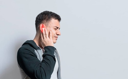 A person with otitis and tinnitus