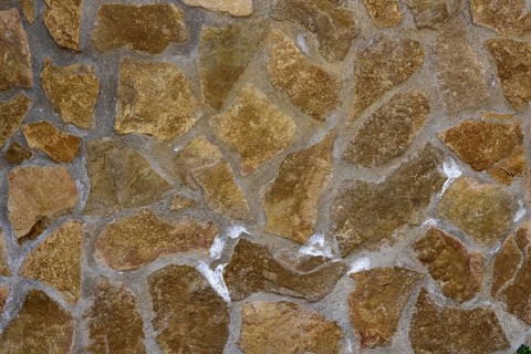 Damp natural stone wall with efflorescent saltpetre Salt