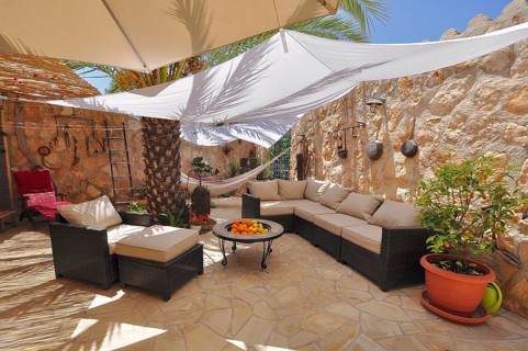 Patio with seating area and awnings