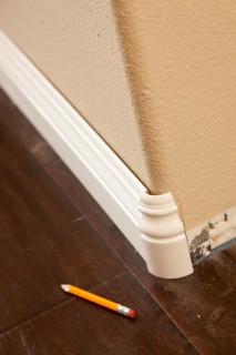 New baseboard and bull nose corners with laminate flooring abstract