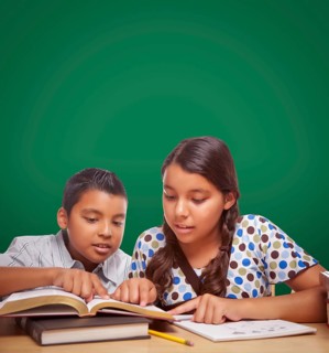 Blank chalk board behind hispanic boy and girl having fun studying together