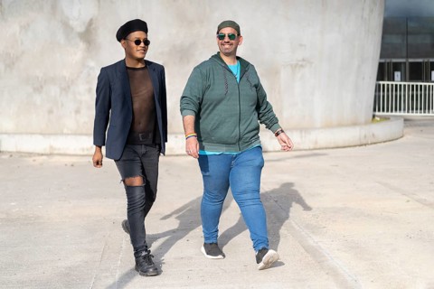 Gay Latino male couple walking in a park