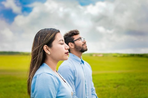 Two people breathing fresh air in the field