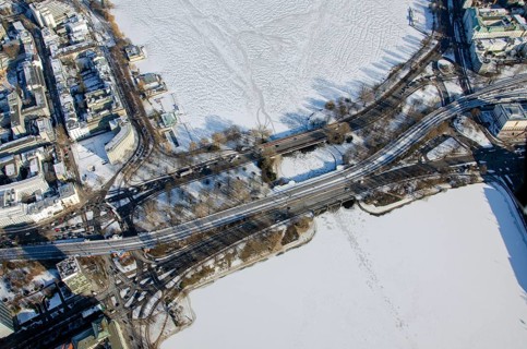 Road and railway bridge over the Alster in winter with ice and snow