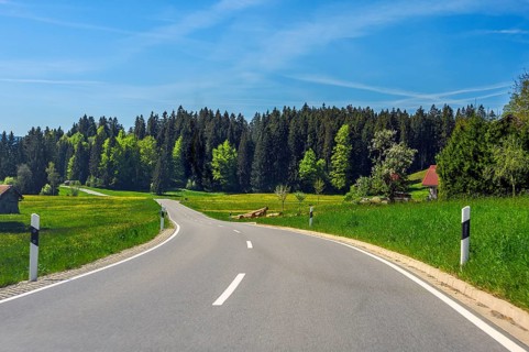 Country road between spring meadows near Stiefenhofen