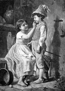 Two children at home. The girl paints the boy's face with war paint