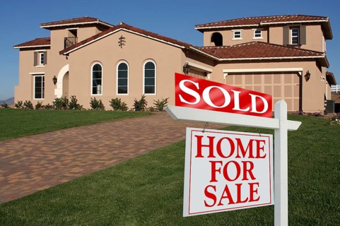 Sold home for sale sign in front of new house