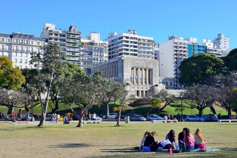 People in the park in front of the flag monument