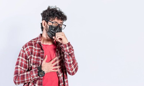 Man coughing with surgical mask