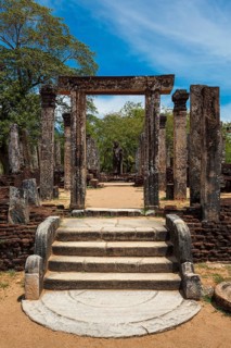 Standing Buddha statue in ancient ruins