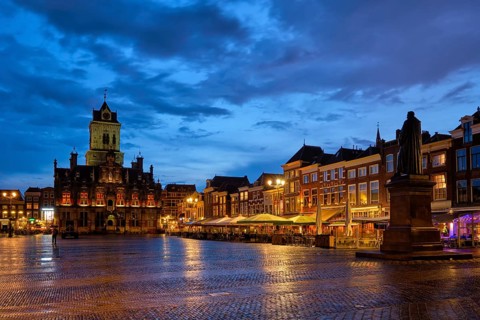 Delft City Hall and Delft Market Square Markt with Hugo de Groot Monument in the evening