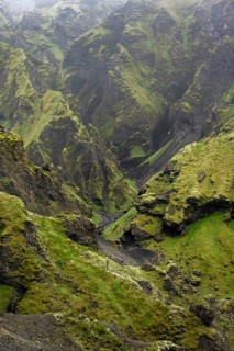 View into rugged moss-covered canyon with tufa rock formations