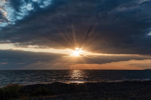 Sunbeams through gap in clouds