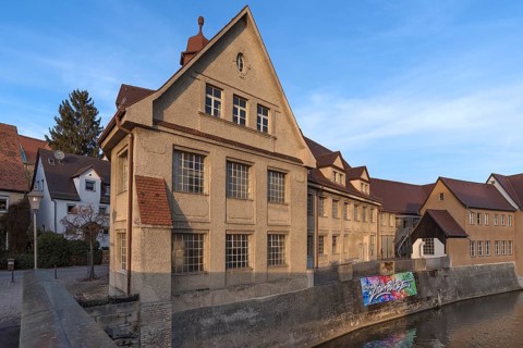 Historic main building of a former valve factory in the evening light