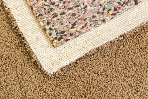 Pulled back carpet and underlay in room of house
