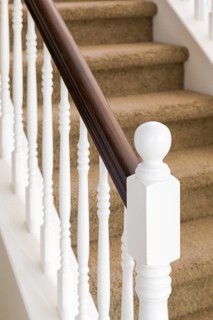 Stair railing and steps with carpet in house