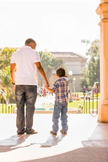 Happy african american father and mixed-race son walking at the park