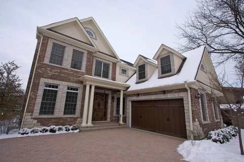 Majestic newly constructed home facade on a blustry winter day