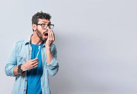 Person with brush with bad breath problem