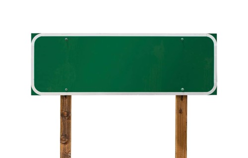 Blank green road sign with wooden posts isolated on a white background
