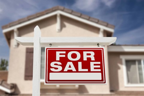 Home for sale real estate sign and house