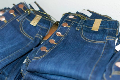 Close up of blue jeans over others