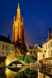 Church of Our Lady and canal illuminated in the night. Brugge Bruges