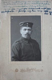 Man in uniform jacket and with cap