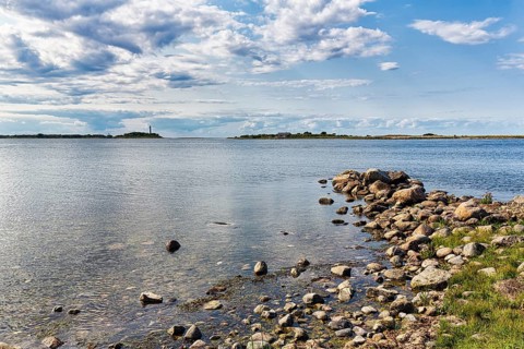 View of lagoon-like bay Grankullaviken with lighthouse Lange Erik on the horizon