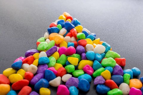 Pile of little colorful pebbles as stone background