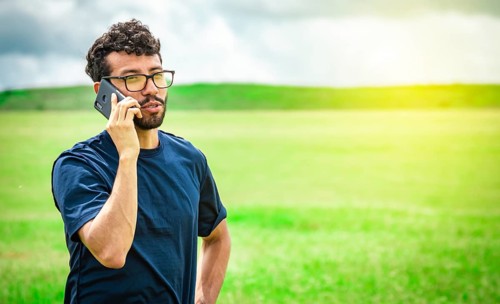 Man calling on the phone in the field