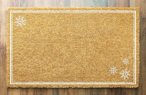 Blank holiday welcome mat with snow flakes on wood floor background
