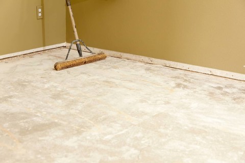 Blank concrete house floor with broom ready for flooring installation