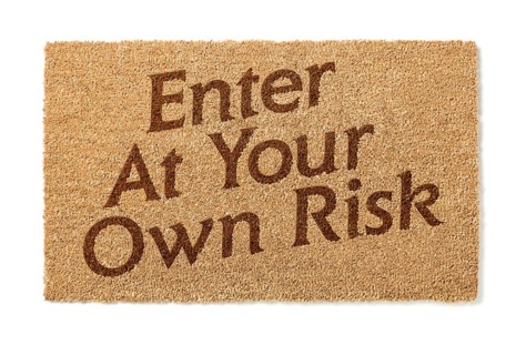 Enter at your own risk welcome mat isolated on A white background