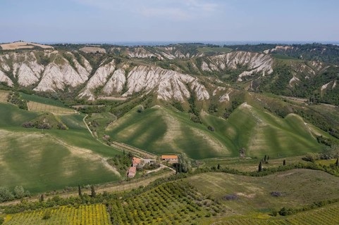 Aerial view of a hilly landscape with erosion valleys