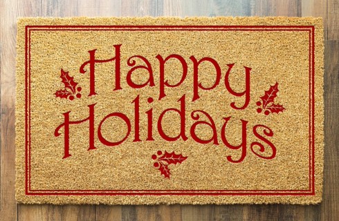 Happy holidays christmas tad welcome mat on wood floor background