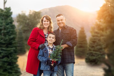 mixed-race family outdoors at christmas tree farm