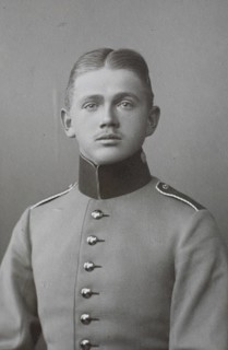 Man in uniform with correct centre parting and high collar