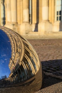 Reflection of the Palais du Gouvernement in a metal hemisphere