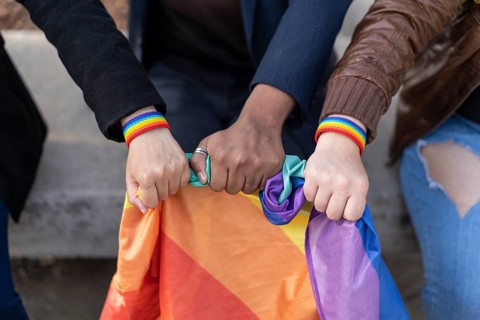 Multi ethnic lgbt gruup wearing lgbt wristbands