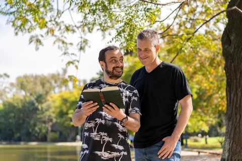 Couple of mature men reading in a lake
