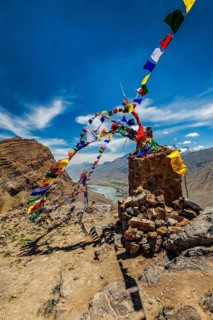 Buddhist prayer flags lungta with Om mani padme hum mantra written on them in Spiti Valley in Himalayas