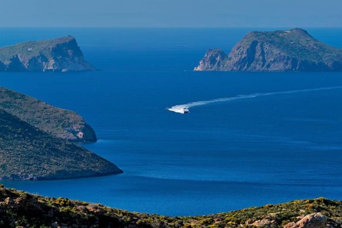 Speeding speed boat catamaran ferry vessel in Aegean sea near Milos island on summer day in Greece