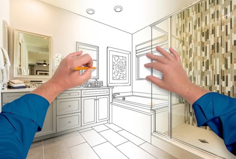 Male hands sketching beautiful custom bathroom gradating to finished construction