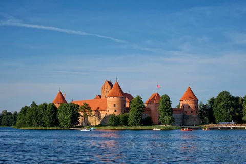 Trakai Island Castle in lake Galve with boats and yachts in summer day with beautiful sky