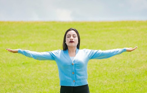 A girl spreading her arms in the field