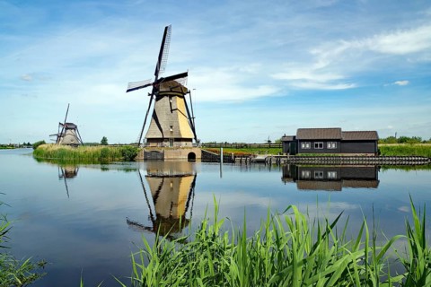 Historic windmills reflected in a canal