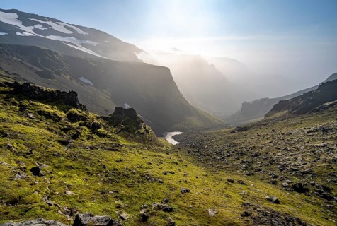 View into canyon with moss and black volcanic stone at Heljarkambur