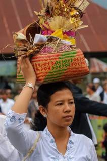 Woman carrying offerings in woven basket