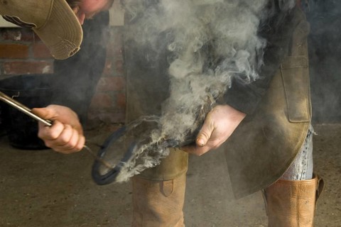 Fitting the red hot horseshoe to the hoof